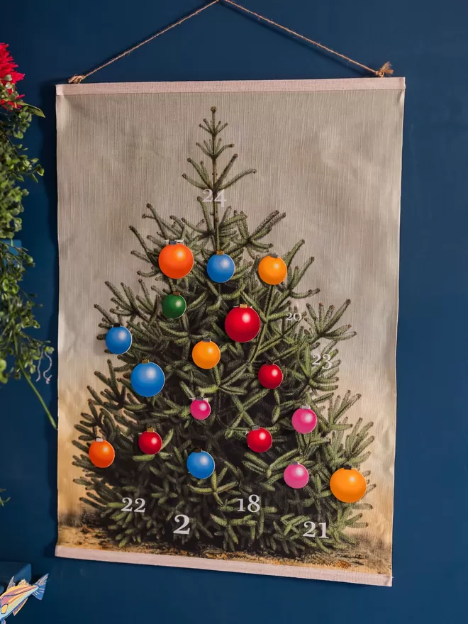 A partially decorated Christmas tree wall hanging