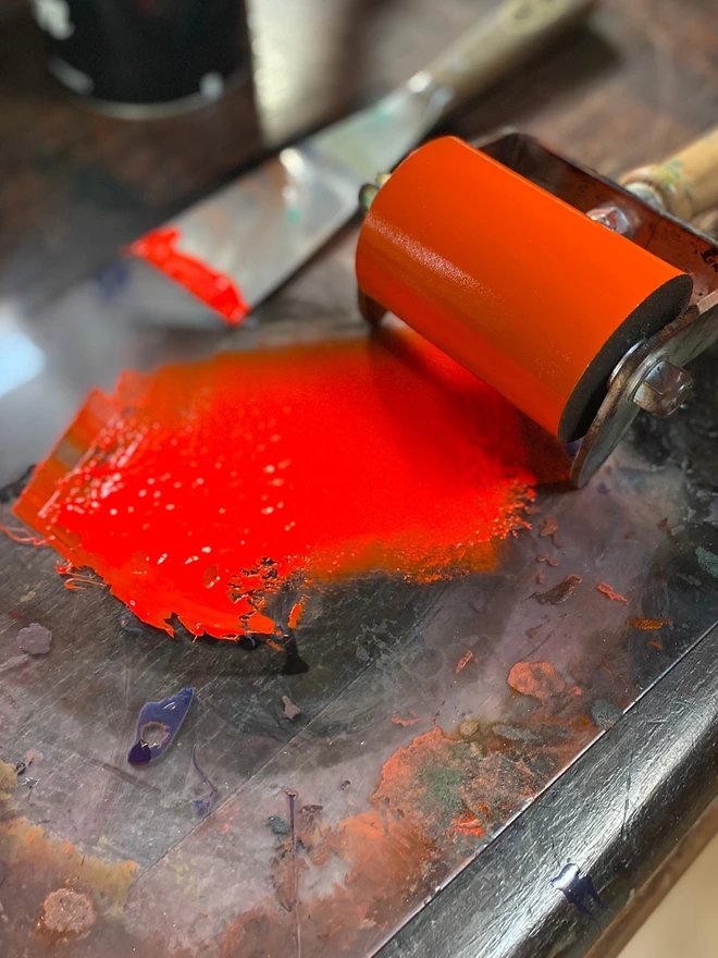 Bright orange ink rolled out with roller and pallet knife.