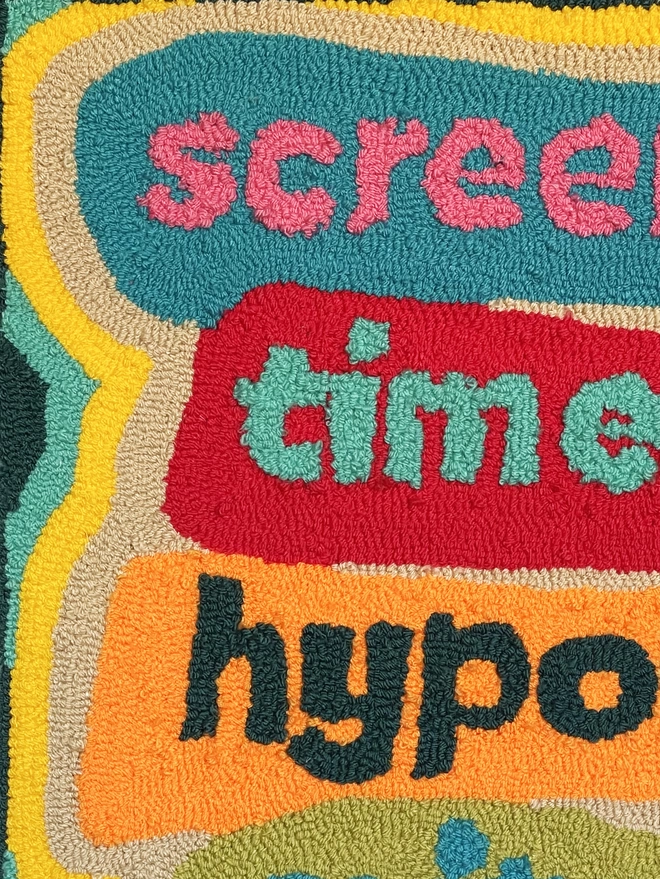 flat close up of tufted art piece which reads "scree time hypo"