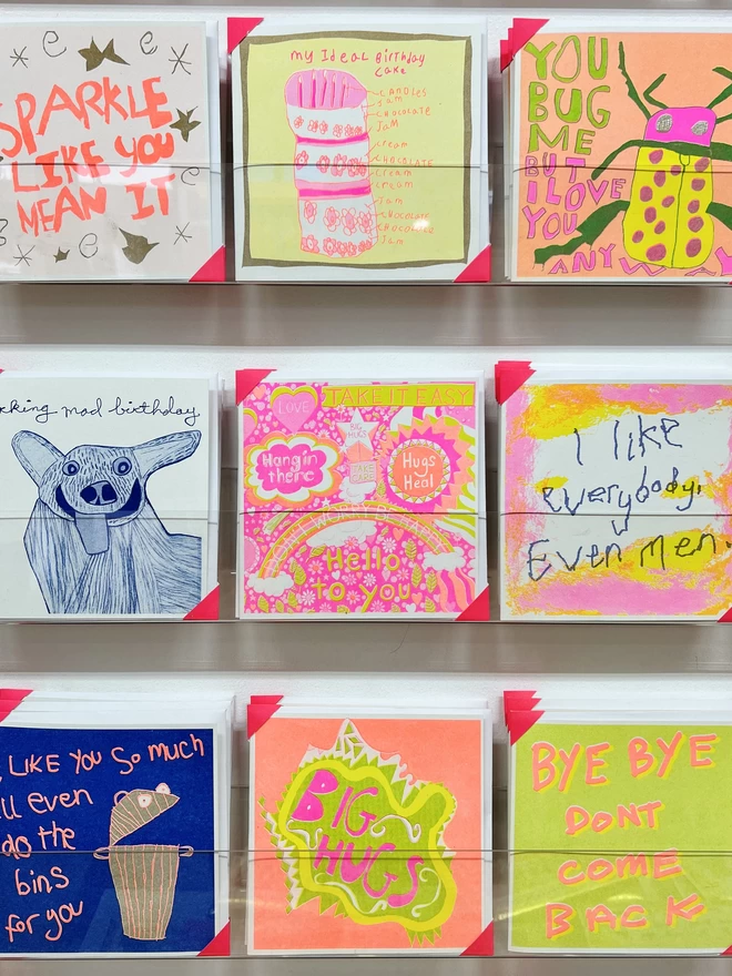 Take it Easy card, a bright & detailed riso print get well soon card on a rack with other cards