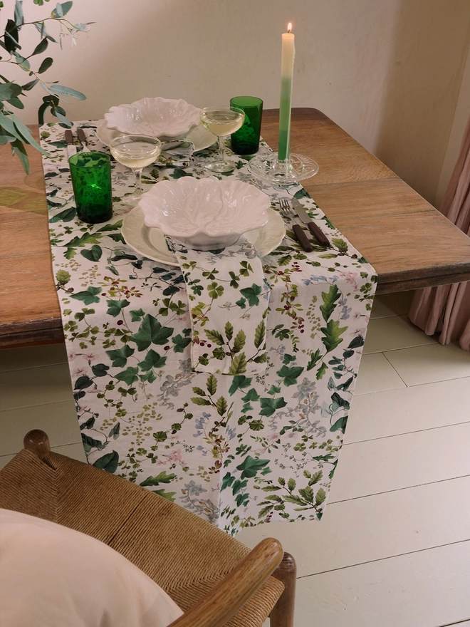 Table laid with linens printed with leaves and flowers