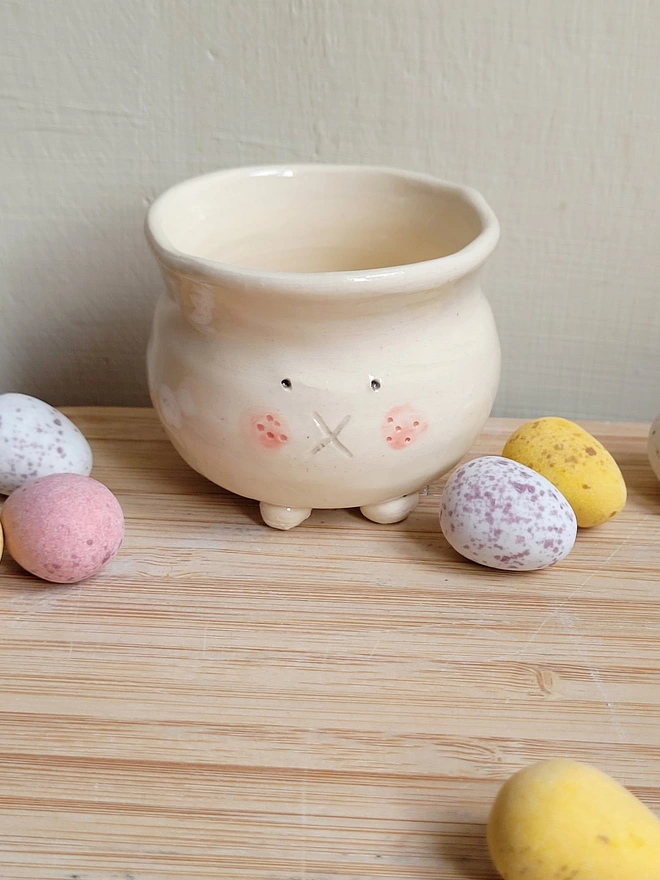a bunny rabbit egg cup holder with mini chocolate eggs 