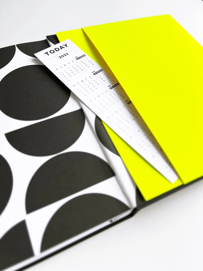 Close up of the Neon Yellow planner pocket containing a bookmark.