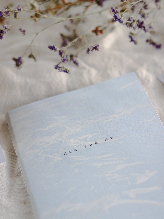 close up of the cover - blue personalised notebook with the words 'mum and me' typed on the cover