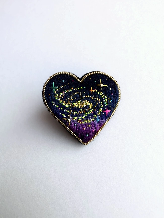 cosmic heart brooch on white background