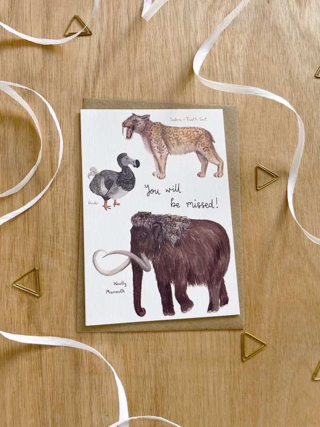 a greetings card featuring a dodo, a sabre tooth tiger and a woolly mammoth with the phrase “you will be missed”