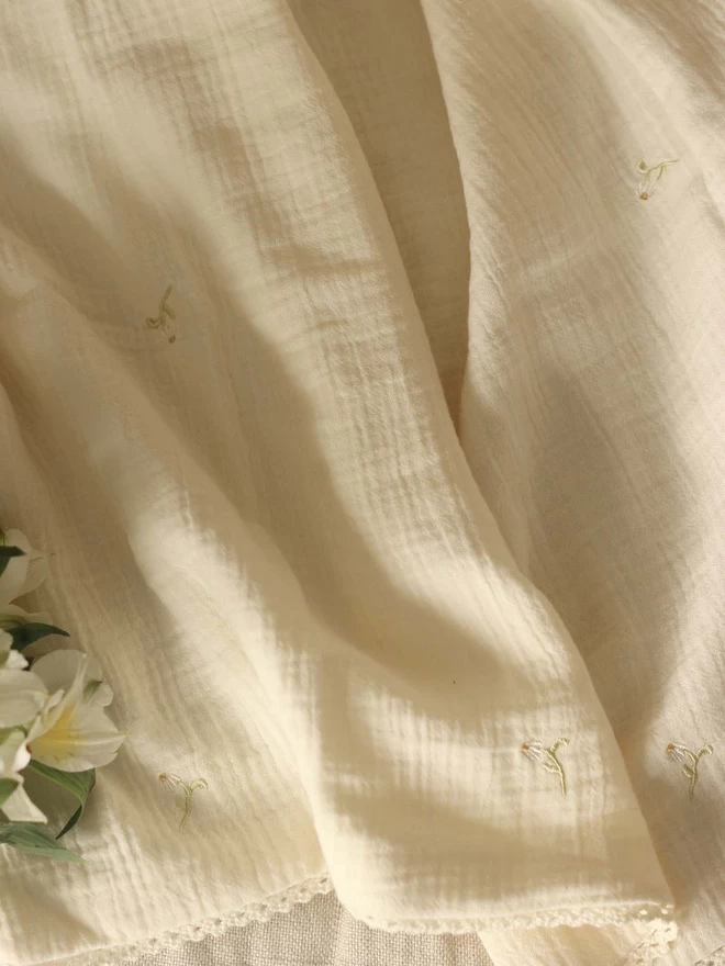 A stylish embroidered muslin blanket
