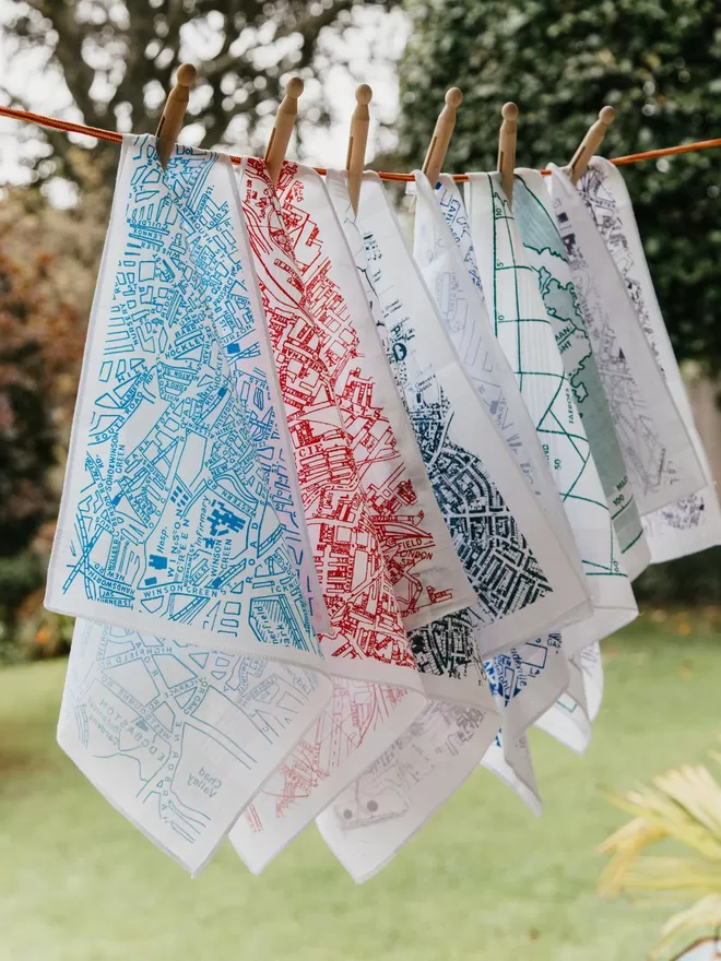 A selection of Mr.PS map hankies pegged on a washing line