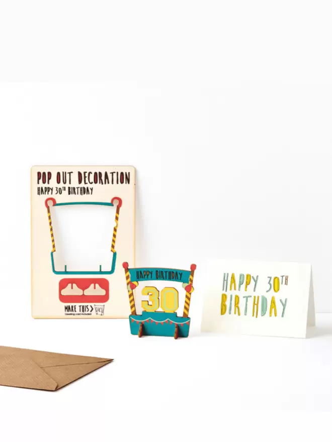 Thirtieth birthday decoration and happy thirtieth birthday card and brown kraft envelope on a white background