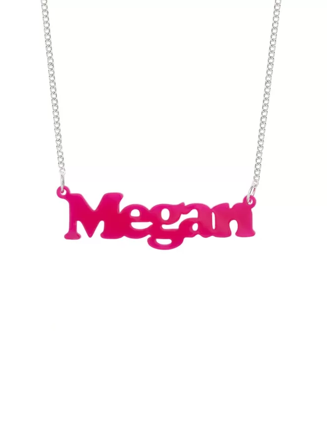 Personalised Name Neckace from Tatty Devine. The Necklace is the word Megan laser cut from Recycled Pink Acrylic on a silver-plated chain.