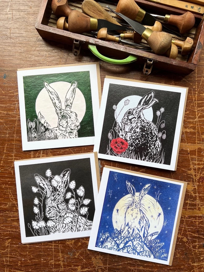 four hare and flower cards. snowdrops, poppy, honesty and harebells