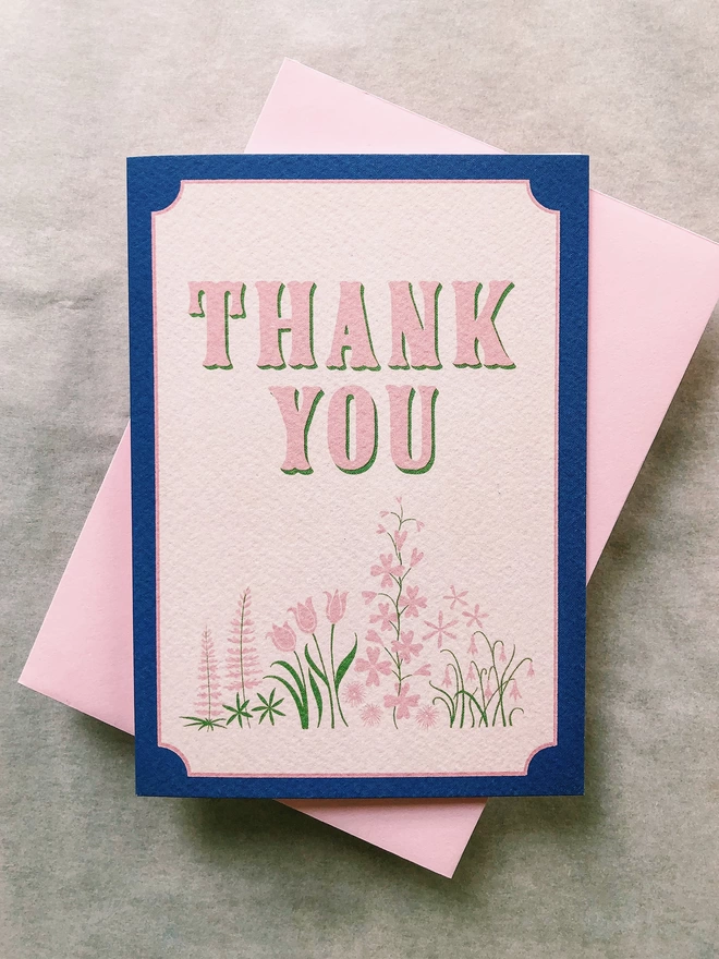 Vintage style typography and lettering in pink and green with hand drawn wild flowers on a high quality printed greeting card