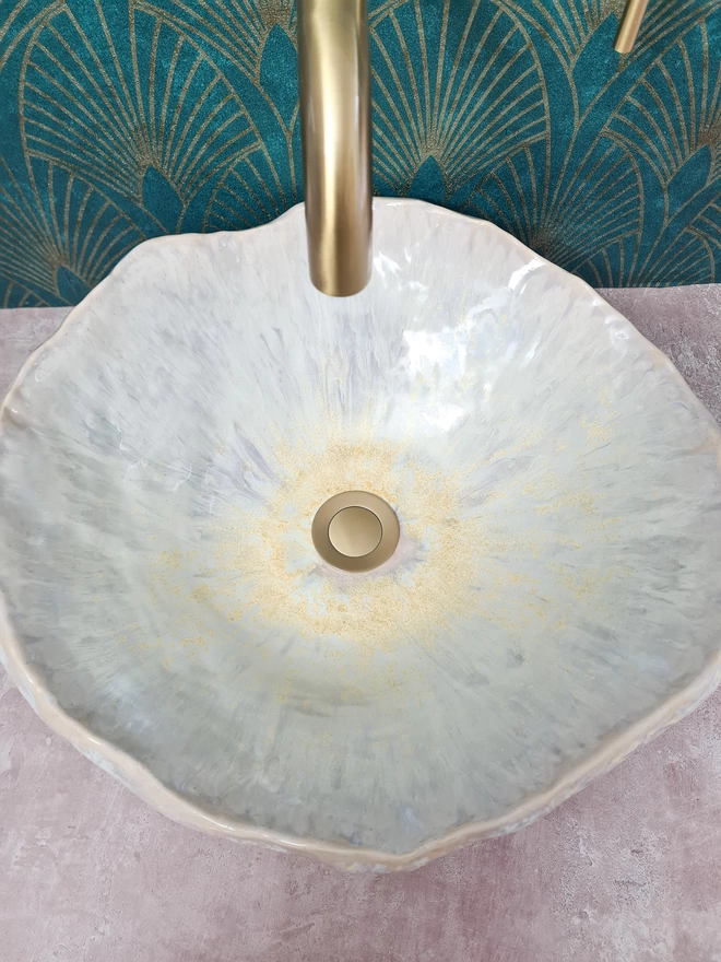 Ceramic bathroom basin, hand-crafted basin, sink, wc, bathroom, ensuite, modern bathroom, photographed against colourful green art deco wallpaper with gold taps, glaze detail, top view