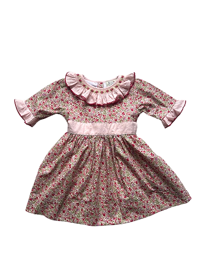 a floral dress with a pink frill collar and hand embroidered detailing