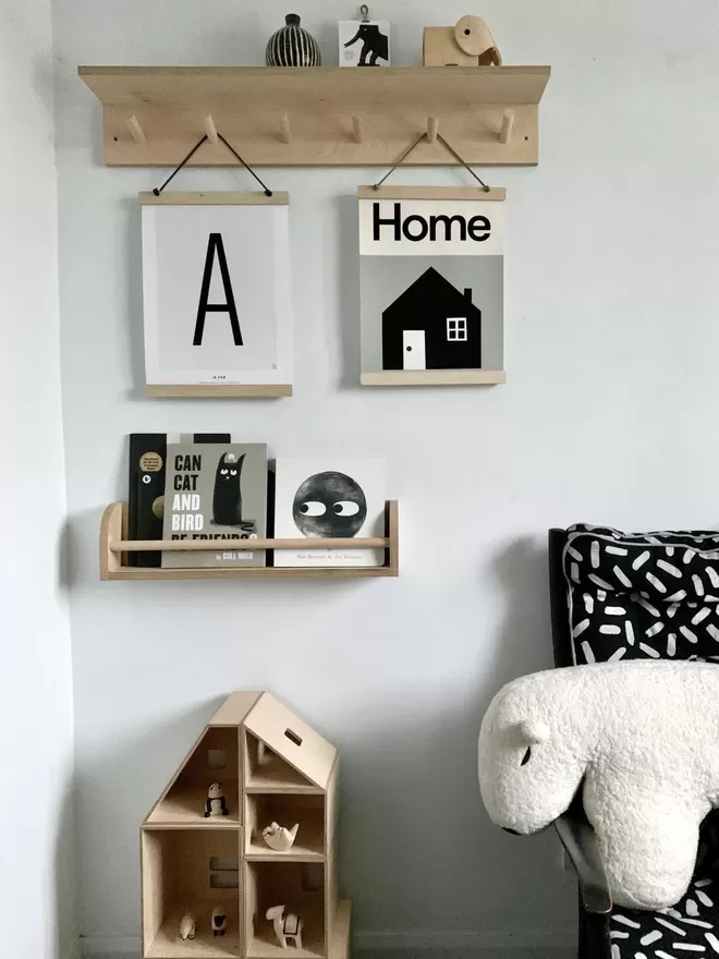 rack in kids room with books, prints hanging and soft toy