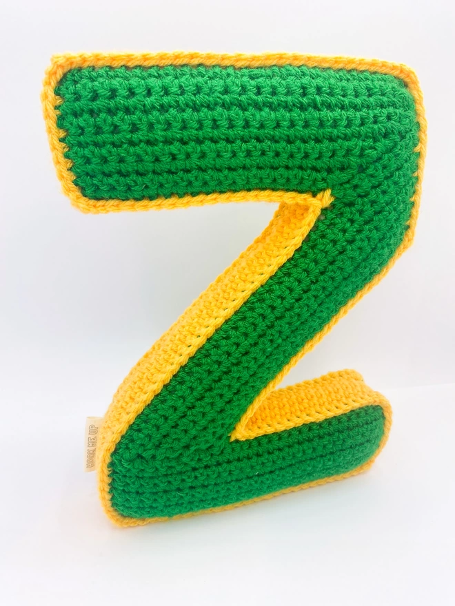Crochet cushion shaped like a Z in Grass Green and Pale Orange