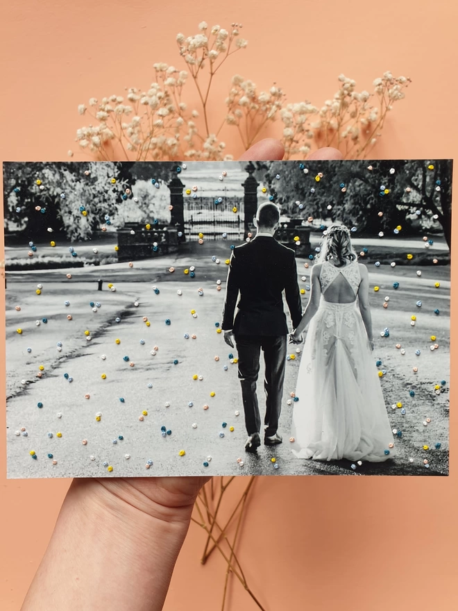  Wedding photo in B&W with hand embroidered french knot confetti held against peach background