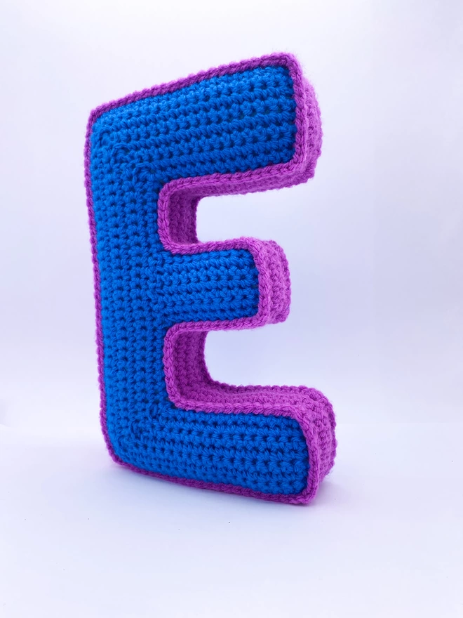 Crocheted E cushion in Blue & Magenta
