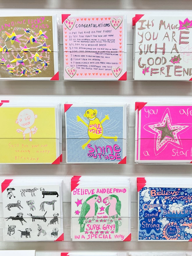 Riso printed encouragement card with the words Smile Inside Shine Outside on a rack
