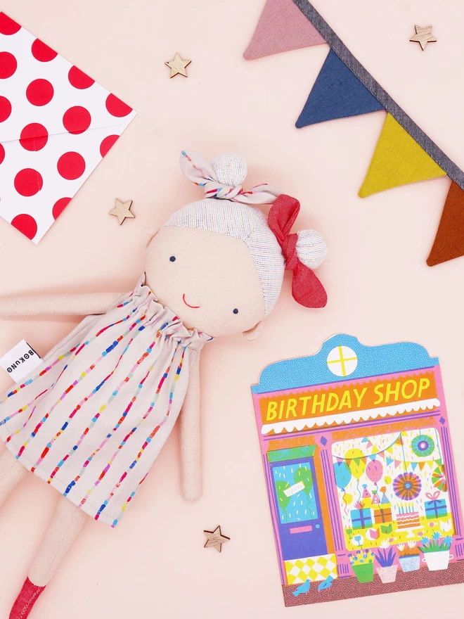 fabric girl doll wearing rainbow stripe dress 