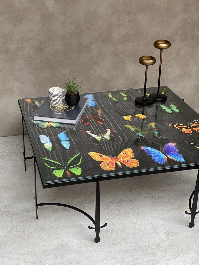 hand built coffee table with glass butterfly artwork on top