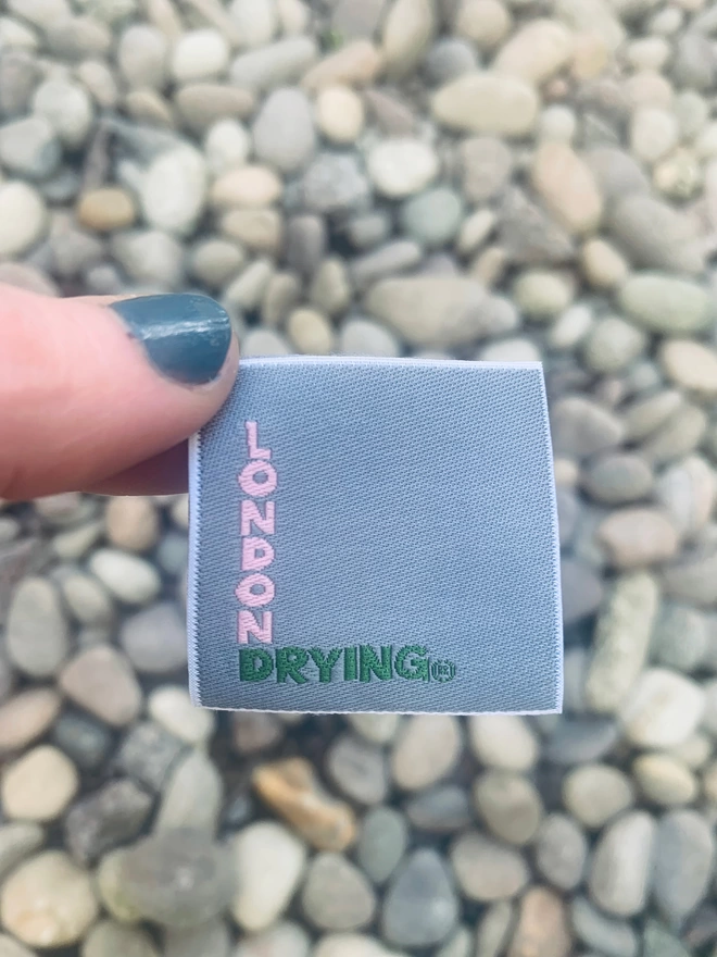 London Drying branded label held above gravel