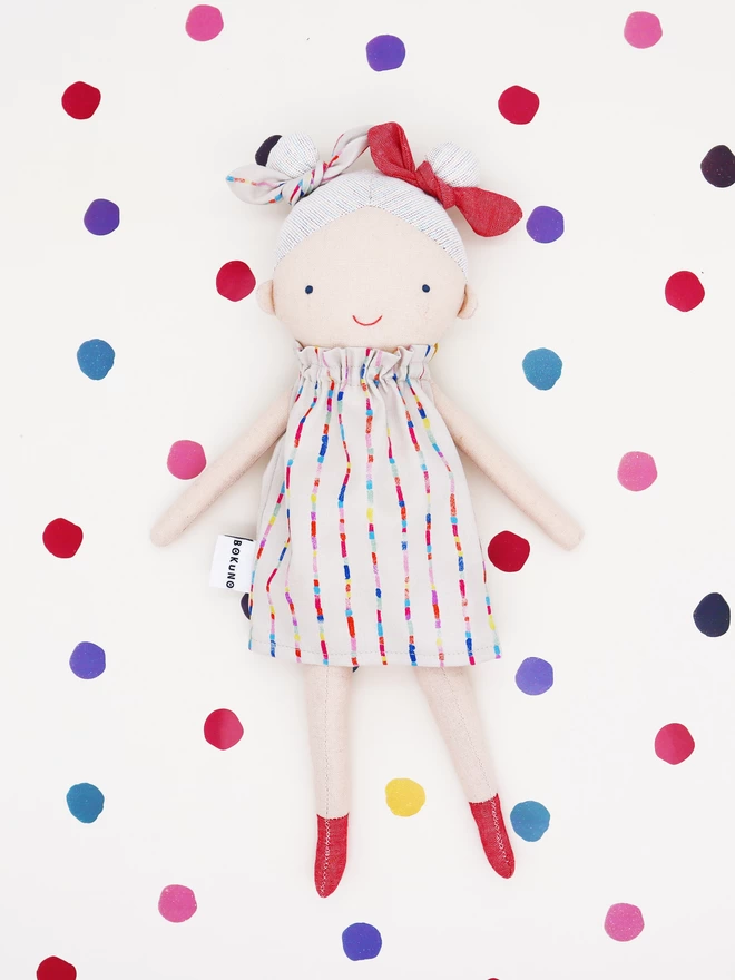 colourful fabric doll with rainbow dress and red boots