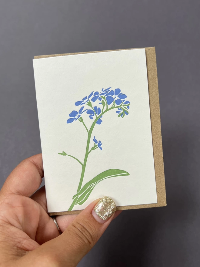 Blue forget me not flower on small note card
