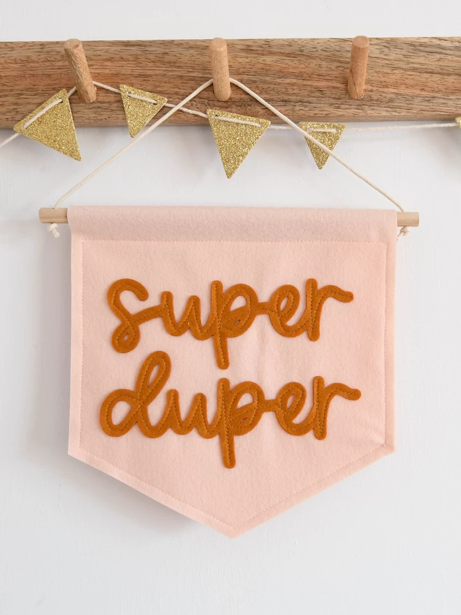 mini felt banner with the words super duper sewn on in cursive font.