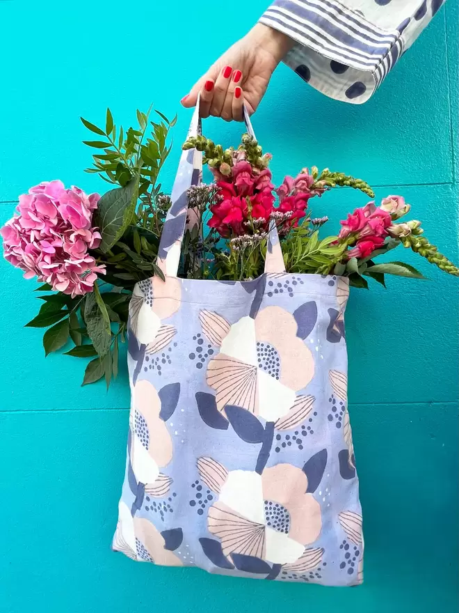Block printed floral tote bag with bright pink flowers inside