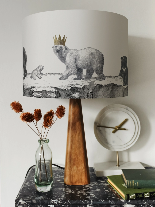Drum Lampshade featuring bears on a wooden base on a shelf with books and ornaments