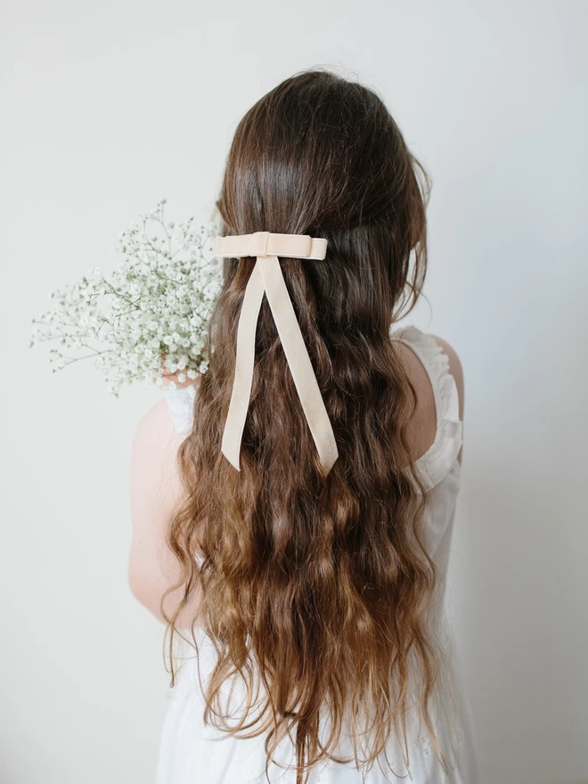 girl with velvet cream hair bow
