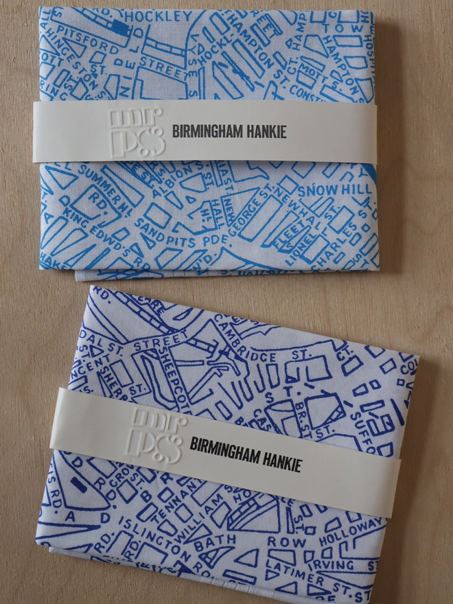 Two folded Mr.PS Birmingham map hankies to show the colour options available: sky blue, and classic blue