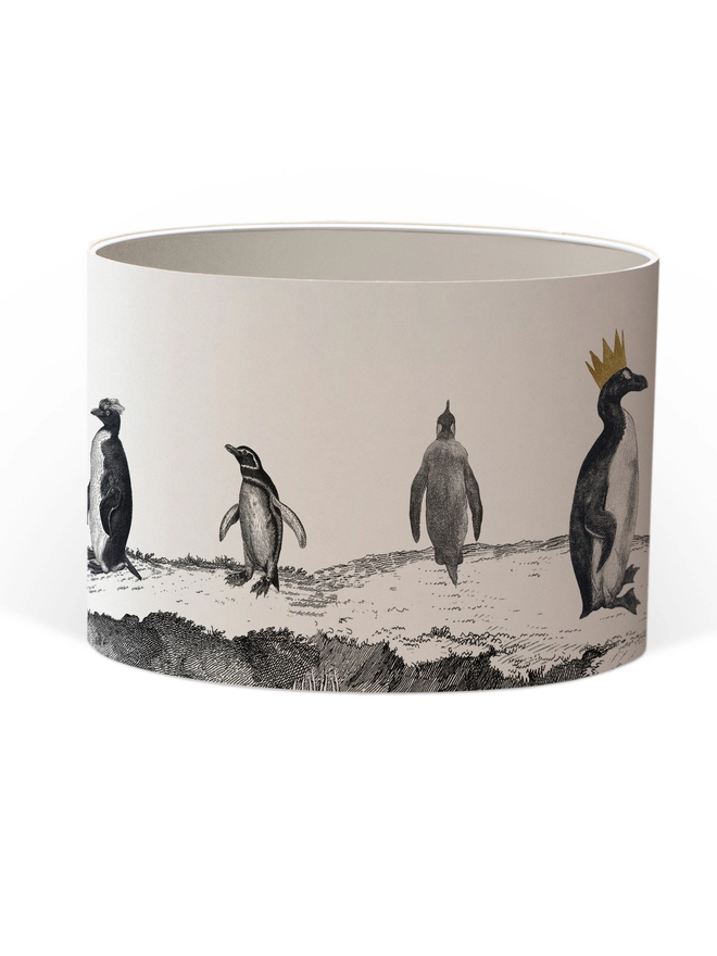 Drum Lampshade featuring a parade of penguins with a white inner on a white background
