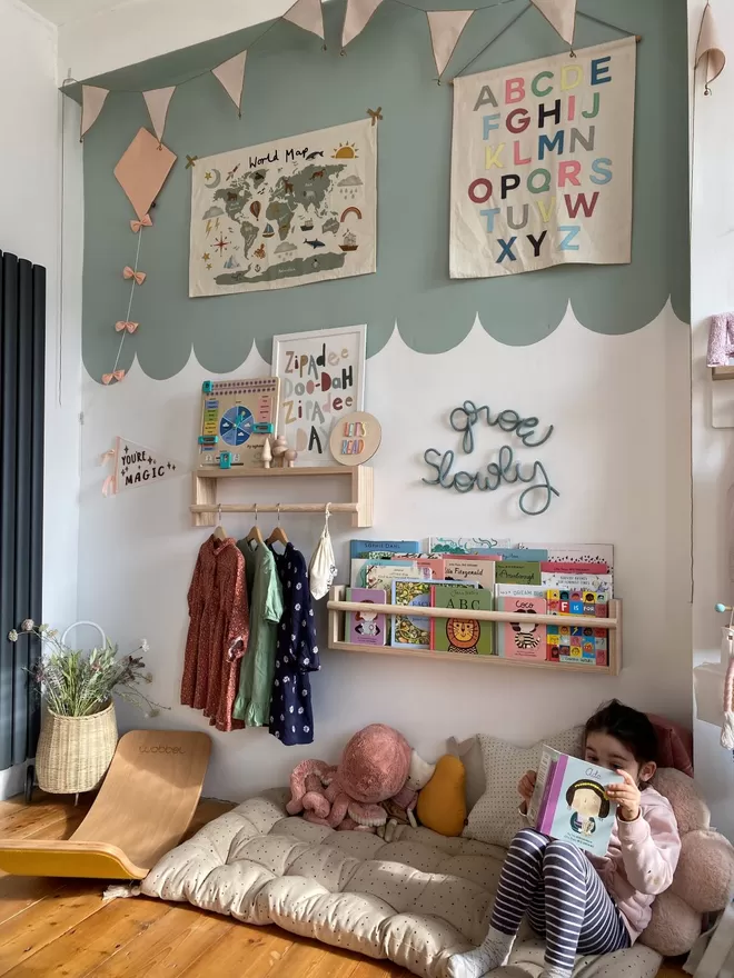 Image of The Flip-It Shelf by Autumn's Corner seen in a kid's bedroom with a child seated reading underneath.