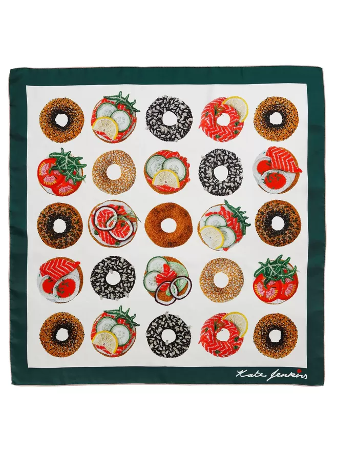 Kate Jenkins hand crotched and embroidered bagels turned into a pattern and printed onto a silk scarf with a green border.