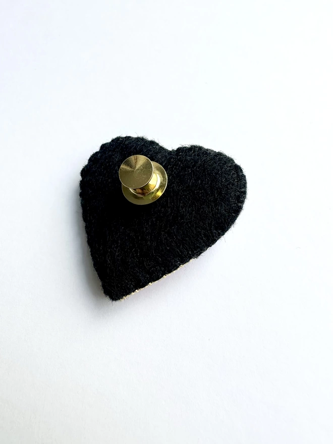 Black felt back of heart shaped brooch with gold pin back