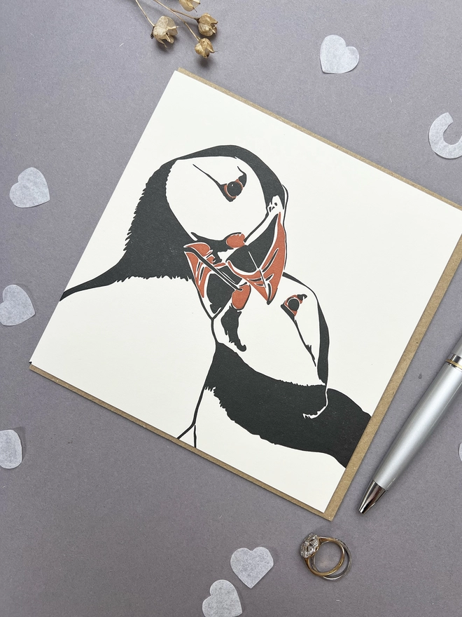 This beautiful card depicts two puffins nuzzling together