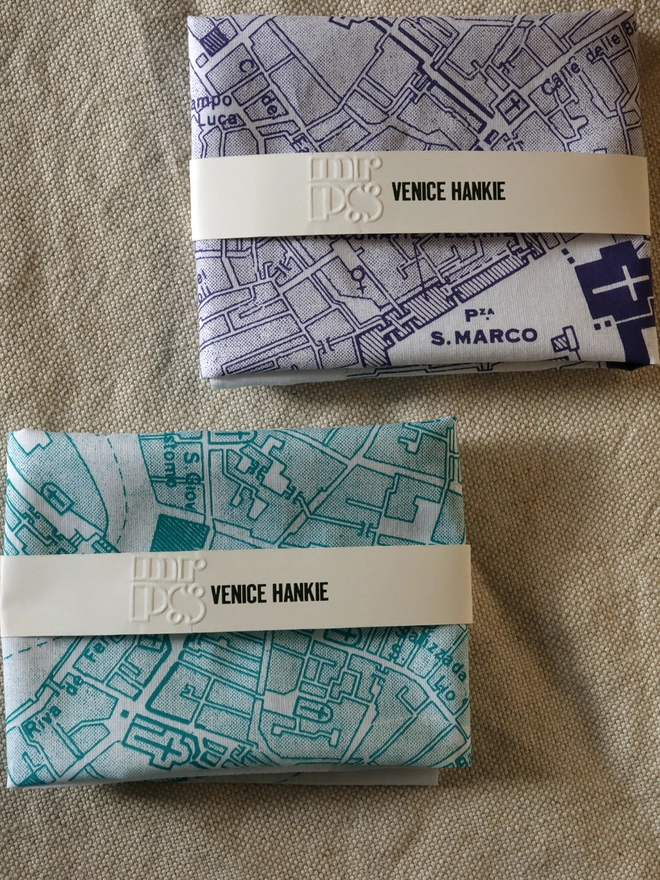Two folded Mr.PS Venice Hankies, one in green and one in violet