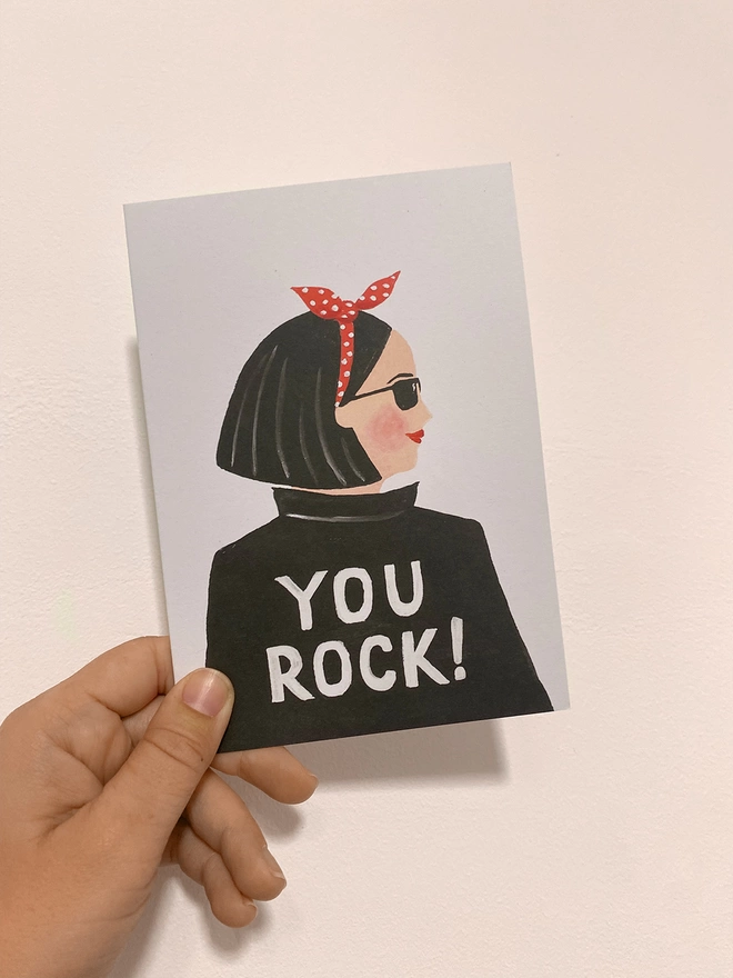 You rock card in hand
