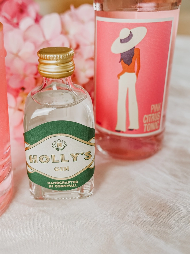 Holly's Mini next to Artisan Drinks Pink Citrus tonic bottle