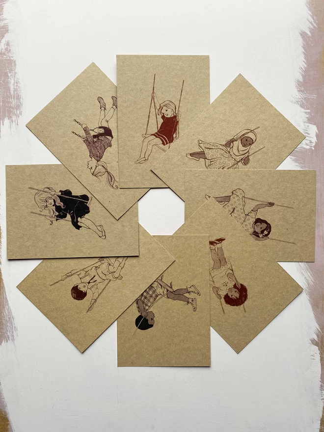 a circle of 8 postcards a6 in size printed in various shades of brown and black ink showing vintage style drawings of little children sat on swings