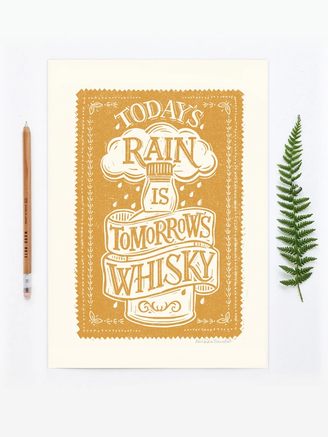 unframed yellow scottish whisky print with fern and wood pencil