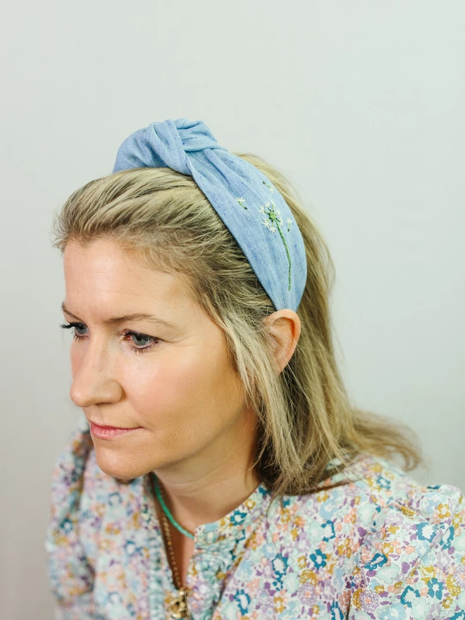 women with blue linen hairband and liberty shirt