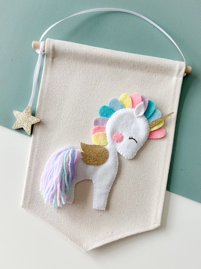 White unicorn with a pastel coloured mane and tail