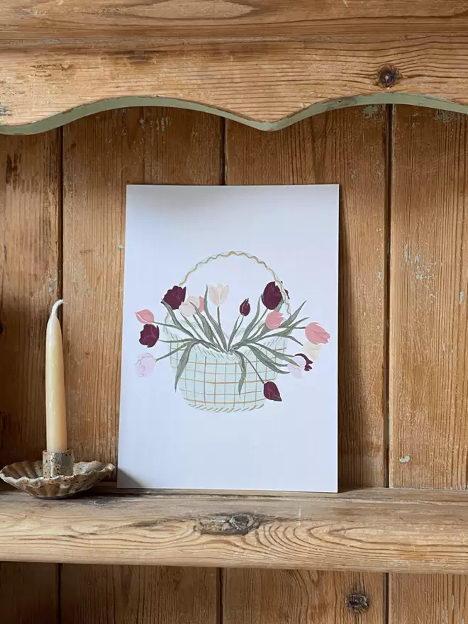 Basket of tulips a5 print on antique shelving. 