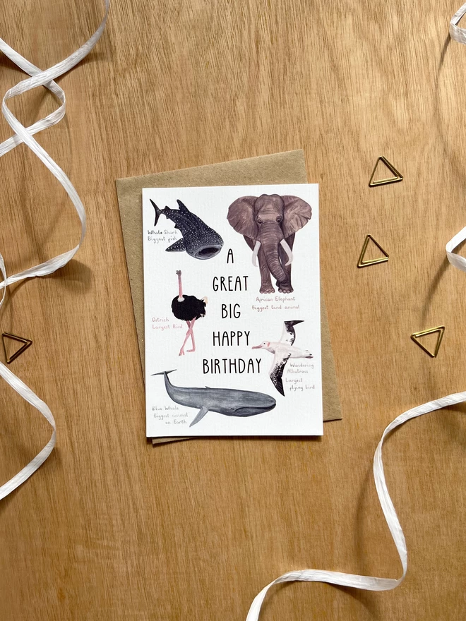 Greetings card featuring the phrase "A great big happy birthday" surrounded by animals who are the biggest of their kind - a whale shark, an elephant, an ostrich, an albatross and a blue whale