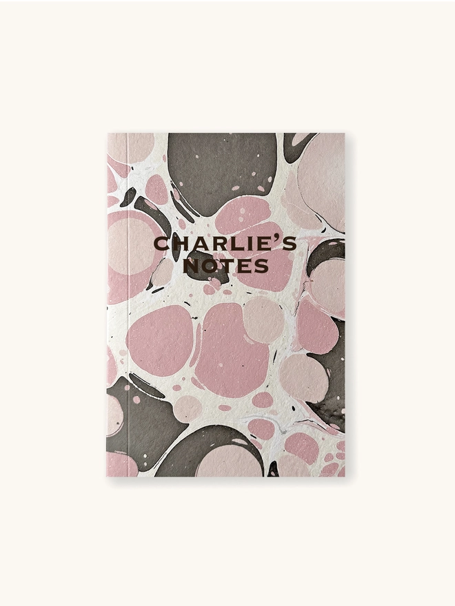front of pink marbled notebook