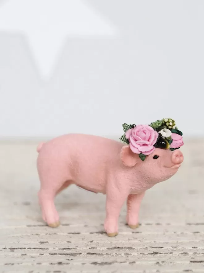 Piglet with a floral headdress.