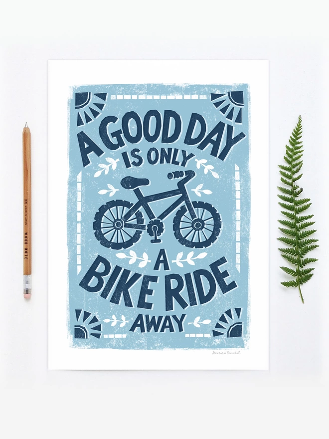 blue cyclists bike ride print unframed with wood pencil and fern